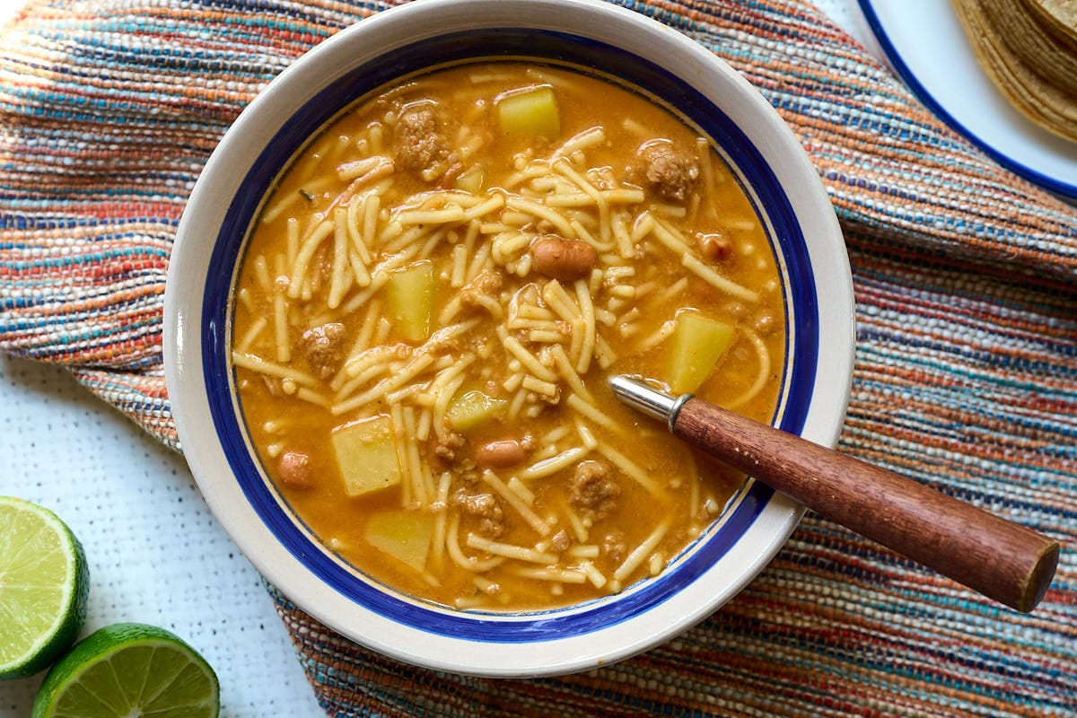 Fideo loco (crazy noodle soup) on a striped napkin.