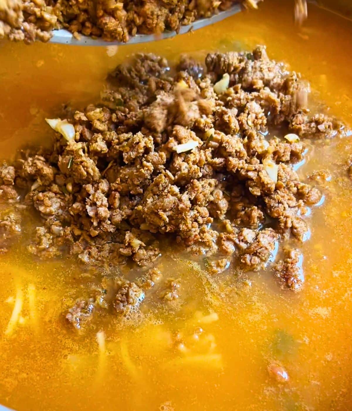 Seasoned ground impossible meat added to the soup.