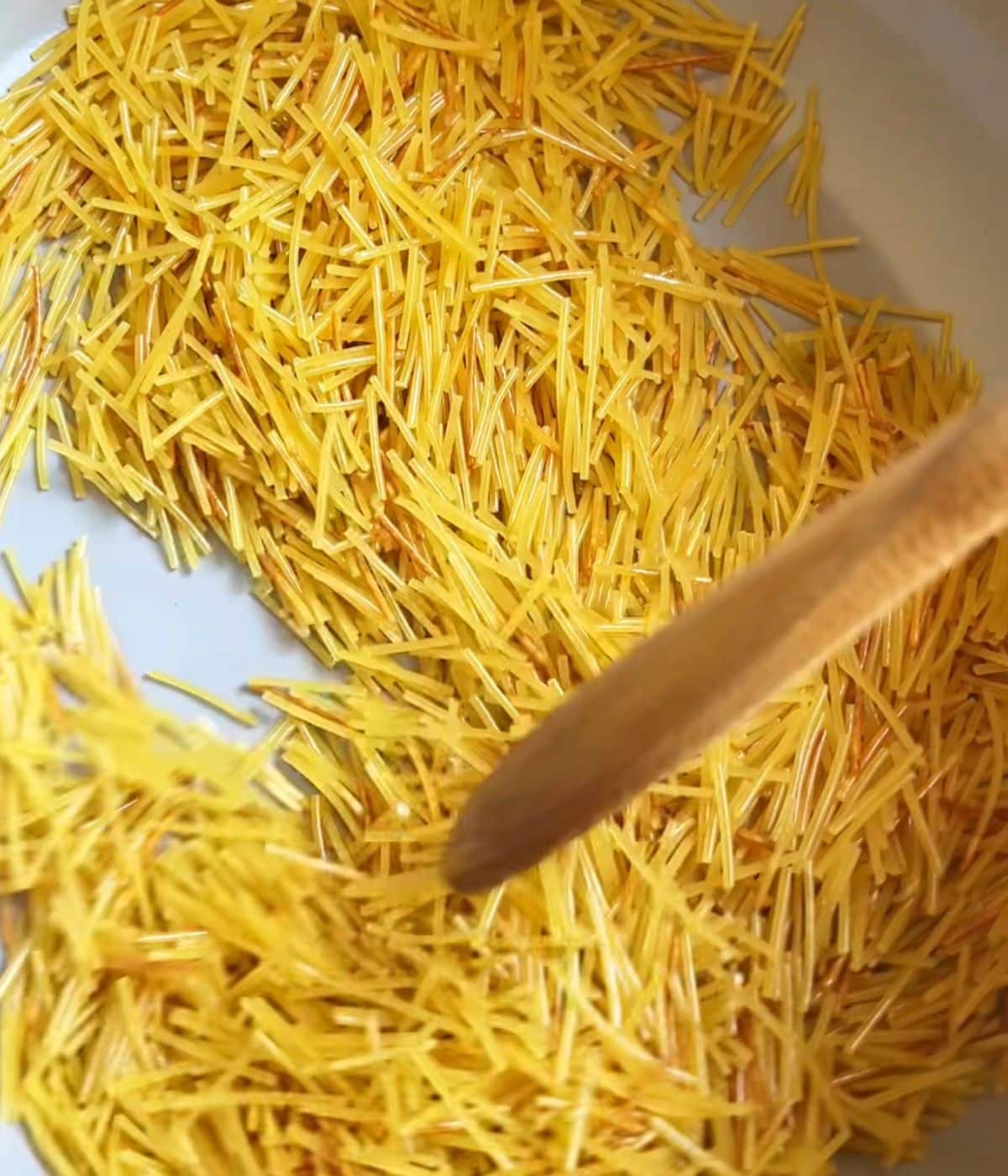 Noodles toasting in a pot.