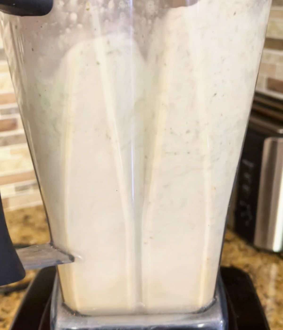 Water and pumpkin seeds being blended.