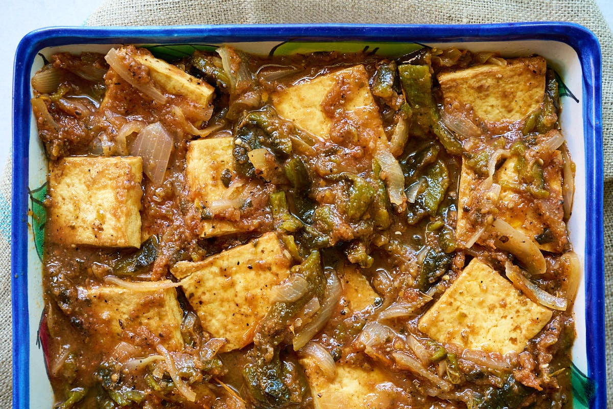 Rajas con queso in a white and blue casserole dish.