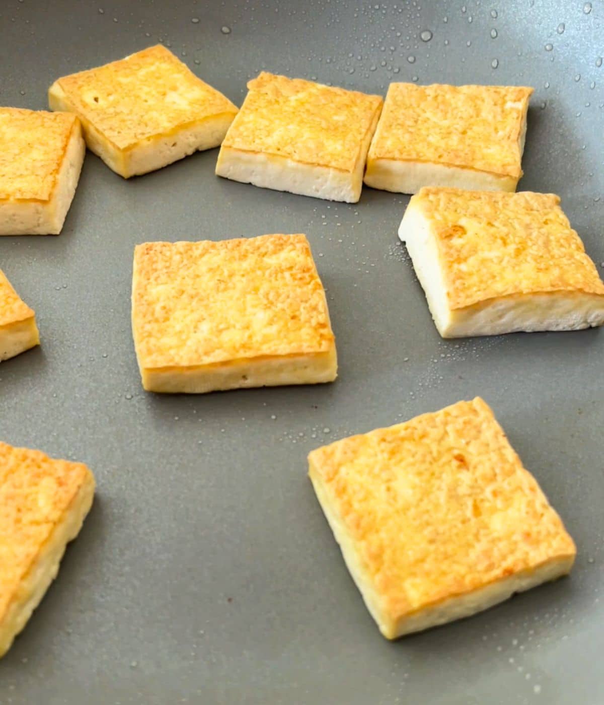 Pan fried tofu in a non-stick skillet.