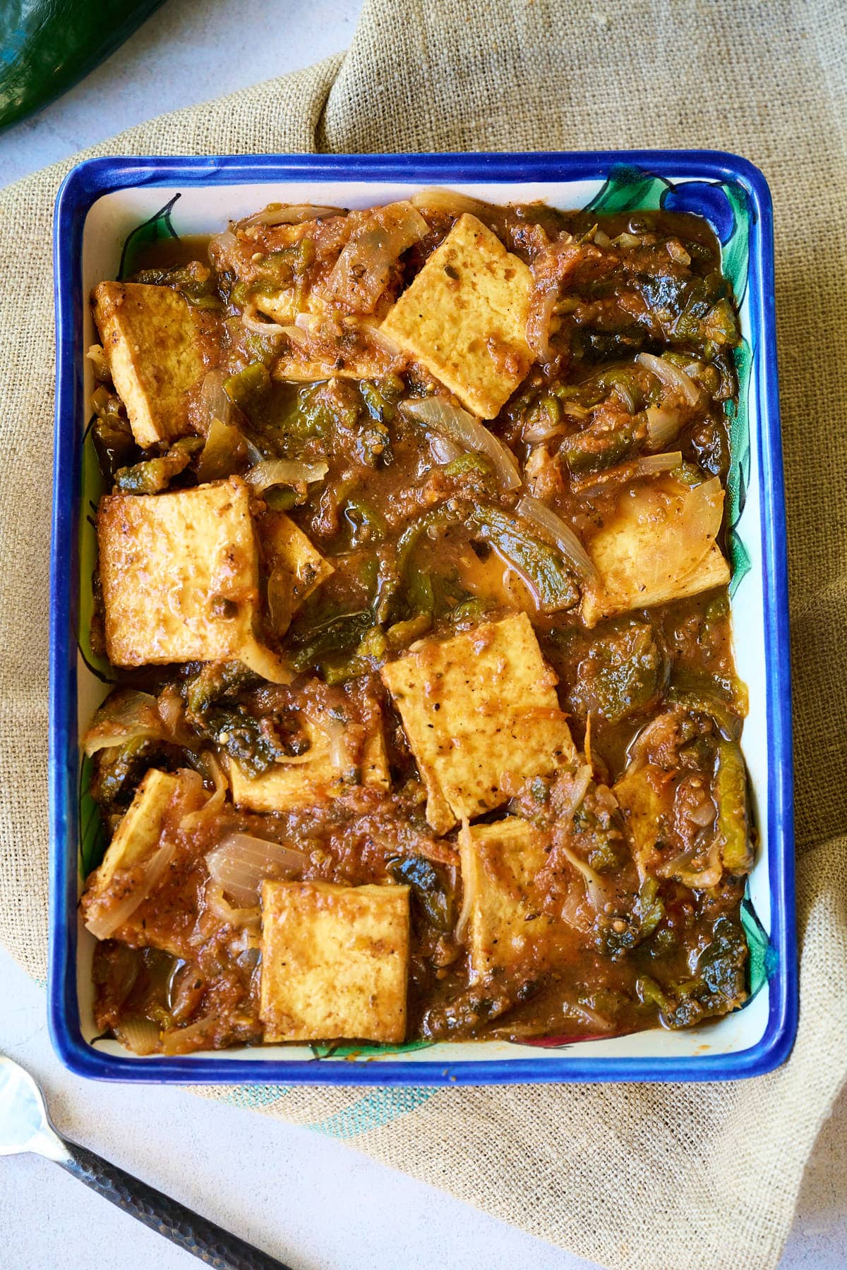 Poblano and Tofu Stew in a white and blue talavera casserole.