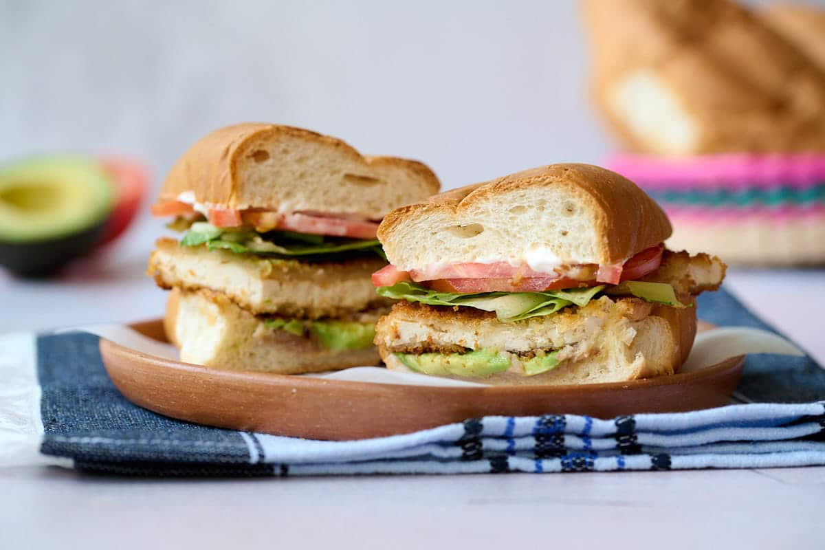 Tofu milanesa sandwich on a plate.