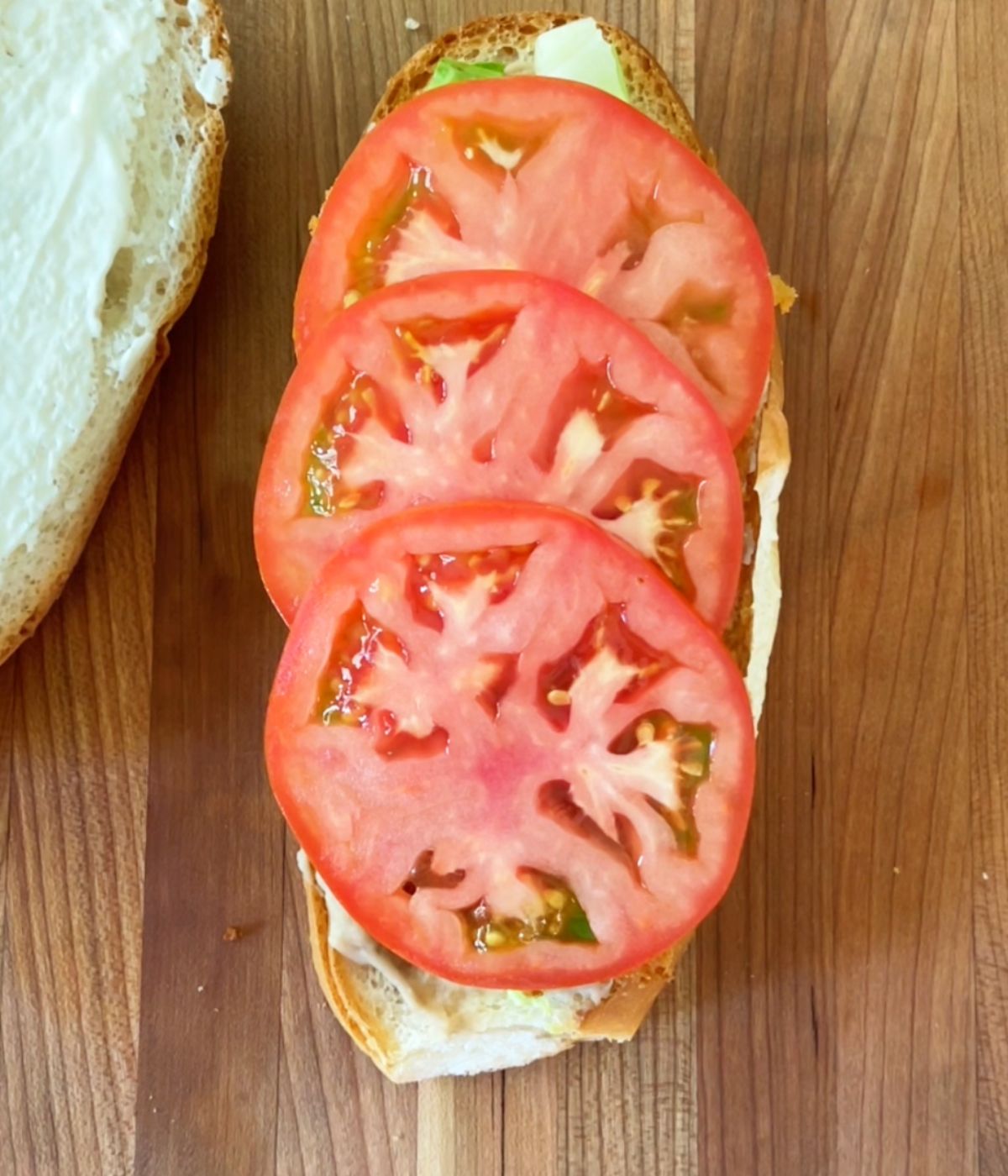 Three tomato slices on top of torta bread.