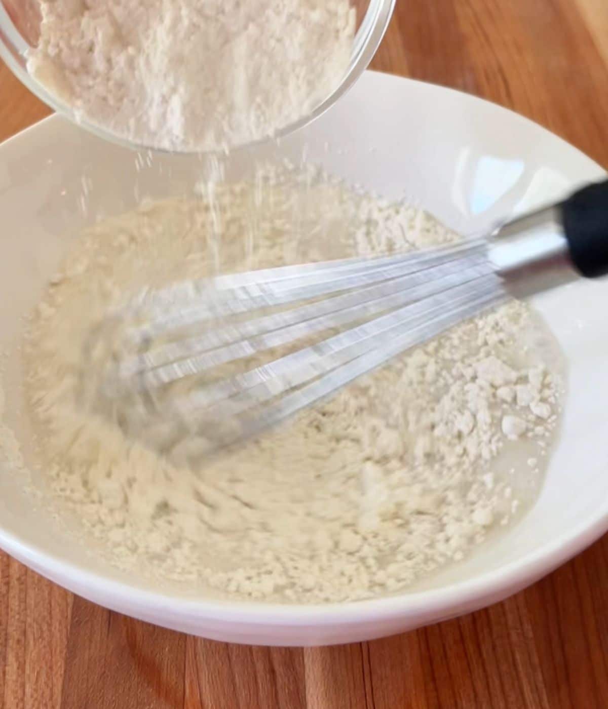 Flour added to bowl with cornstarch and water.